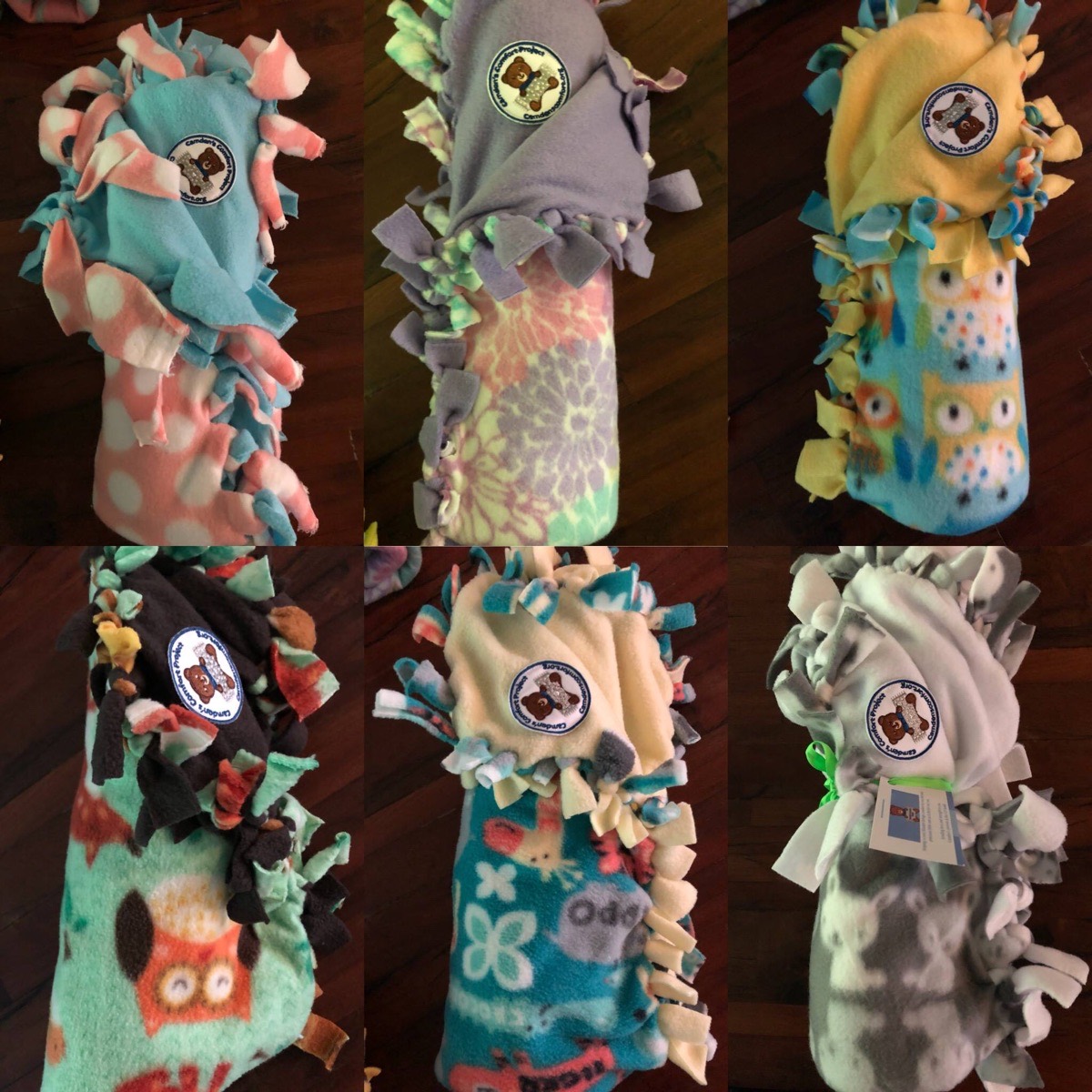 Six rolled fleece blankets, each tied with the Camden's Comfort patch
